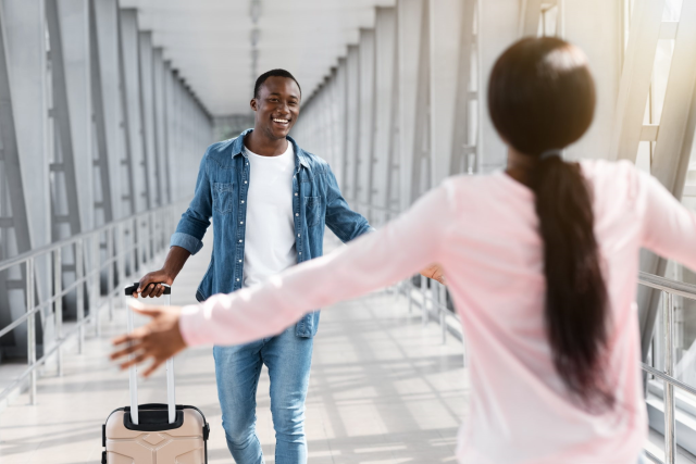 Family members welcoming one another at an airport