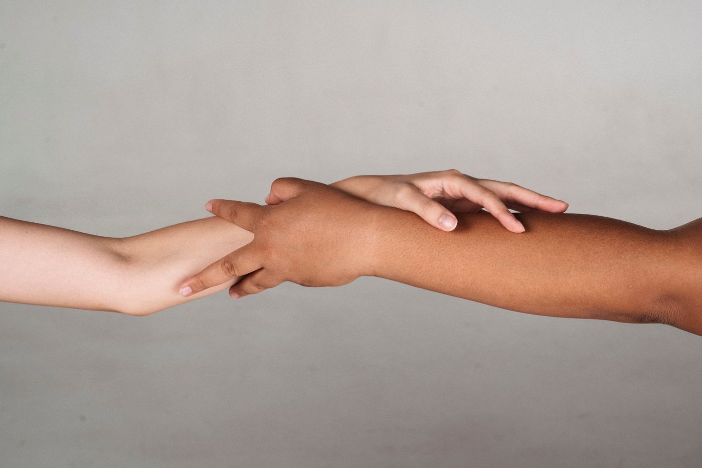 Hands with different skin tones joined together